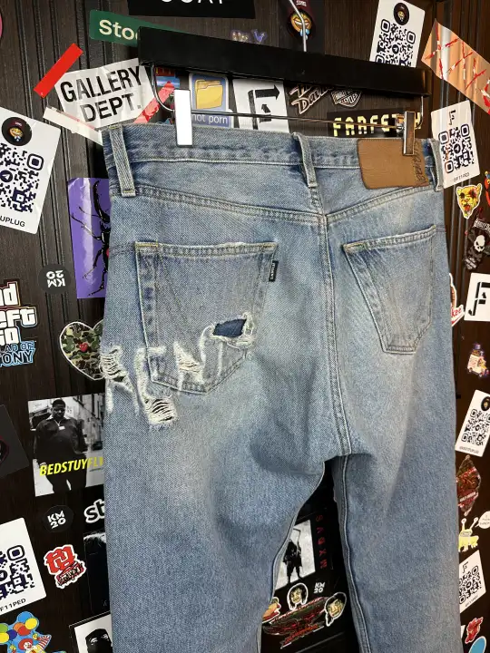 Vetements VETEMENTS FW19 Demna Anarchy Logo Distressed Blue Jeans, detail view 7