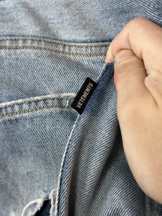 Vetements VETEMENTS FW19 Demna Anarchy Logo Distressed Blue Jeans, detail view 10