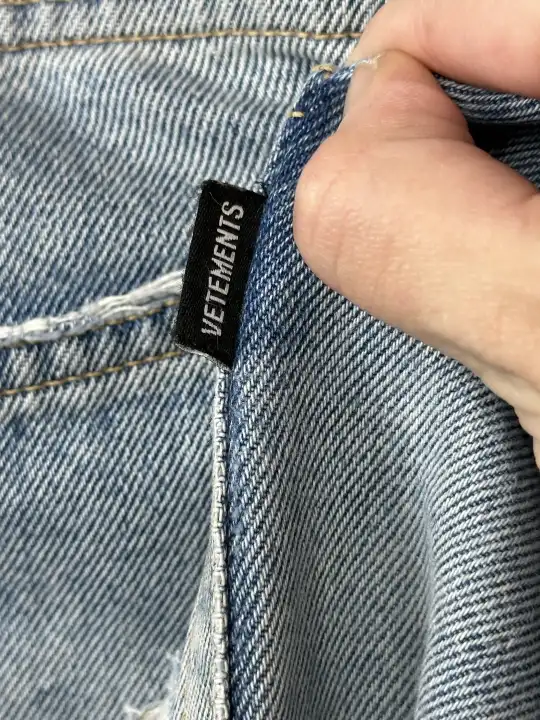 Vetements VETEMENTS FW19 Demna Anarchy Logo Distressed Blue Jeans, detail view 11