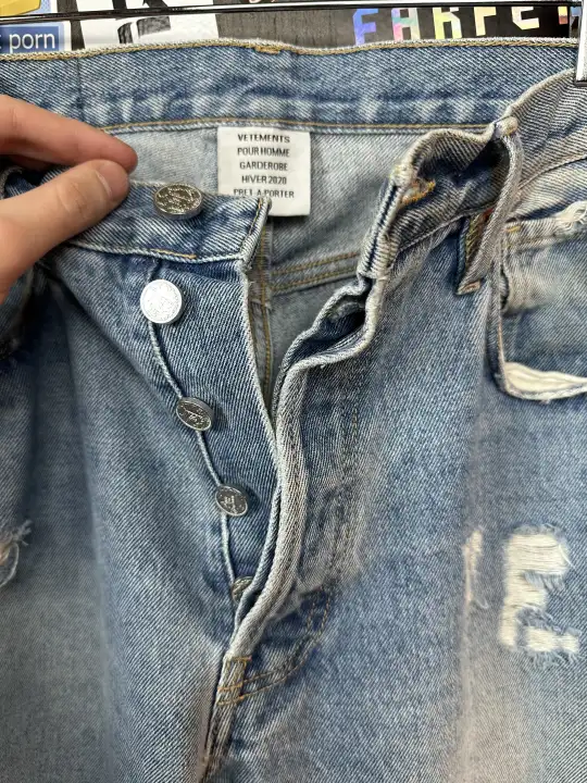Vetements VETEMENTS FW19 Demna Anarchy Logo Distressed Blue Jeans, detail view 12
